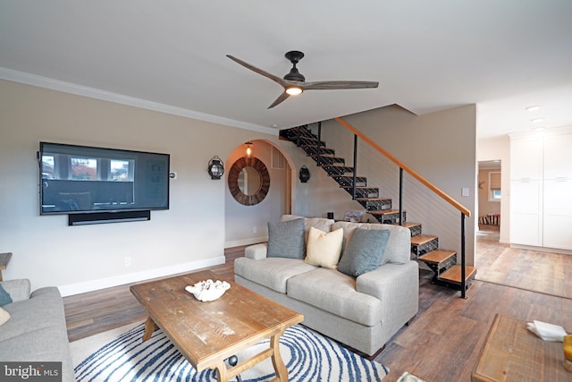 living room featuring hardwood / wood-style flooring, ceiling fan, and crown molding