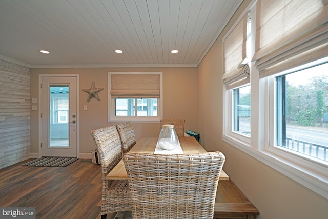 dining room with dark hardwood / wood-style flooring, a wealth of natural light, ornamental molding, and wooden ceiling