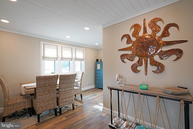 dining area featuring crown molding, wood-type flooring, and wooden ceiling