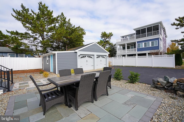 view of patio / terrace featuring a garage and an outdoor structure