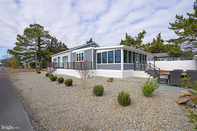 manufactured / mobile home with a patio area and a sunroom