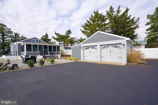 view of front of house featuring a garage and a sunroom