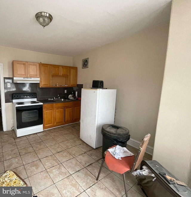 kitchen with decorative backsplash, white appliances, sink, and light tile patterned floors