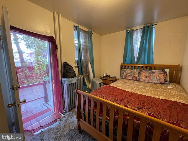 bedroom featuring carpet and radiator