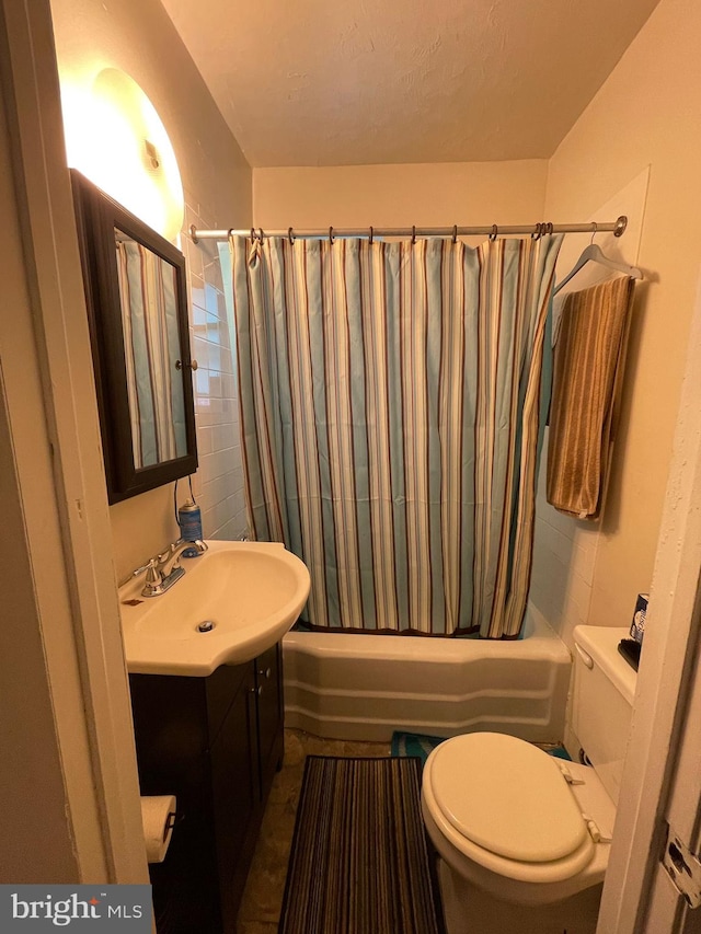 full bathroom with vanity, toilet, and shower / tub combo with curtain