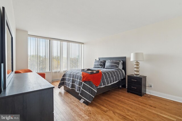 bedroom featuring hardwood / wood-style floors and multiple windows