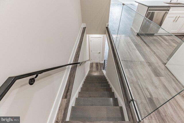 staircase with hardwood / wood-style floors