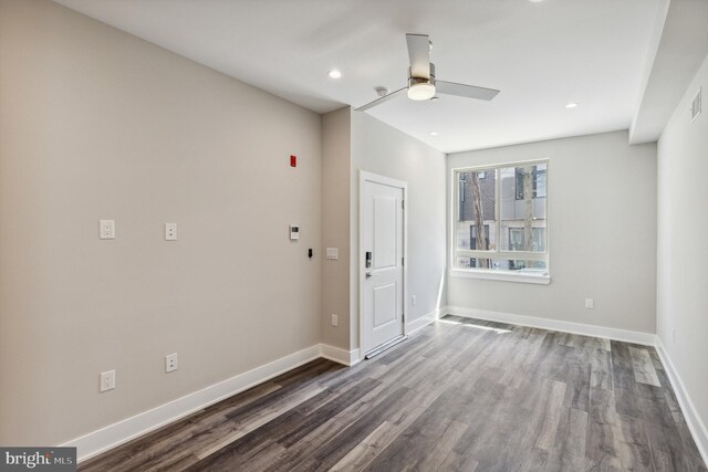 unfurnished room with ceiling fan and dark hardwood / wood-style flooring