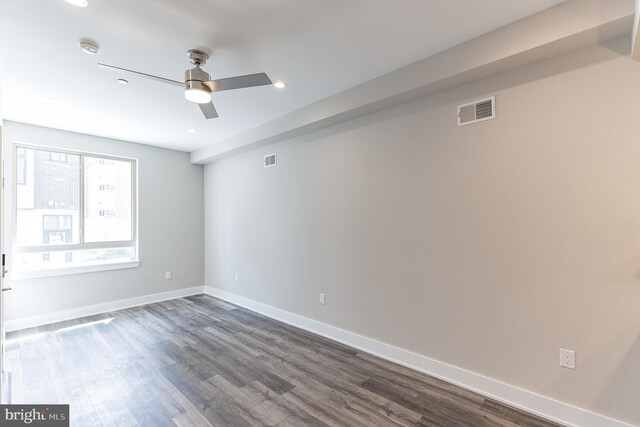 unfurnished room with dark hardwood / wood-style flooring and ceiling fan