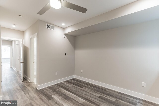 empty room featuring ceiling fan and dark hardwood / wood-style flooring