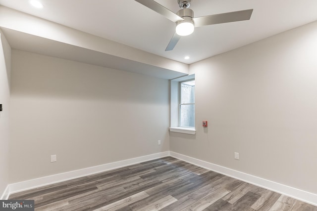 spare room with ceiling fan and dark wood-type flooring