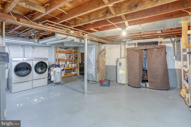 basement featuring water heater and washer and clothes dryer