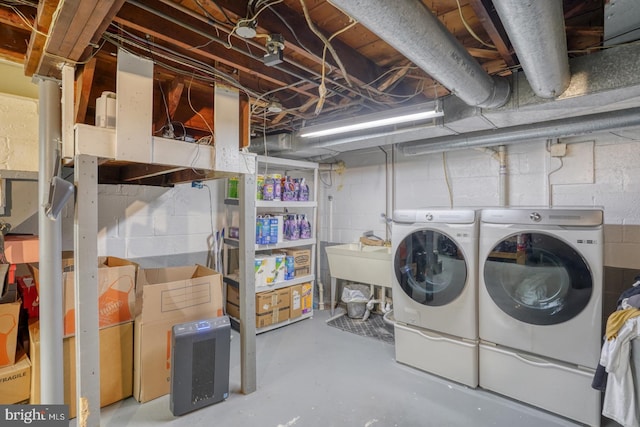 laundry area featuring separate washer and dryer and sink