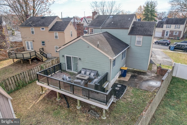 rear view of house featuring a patio area and a deck