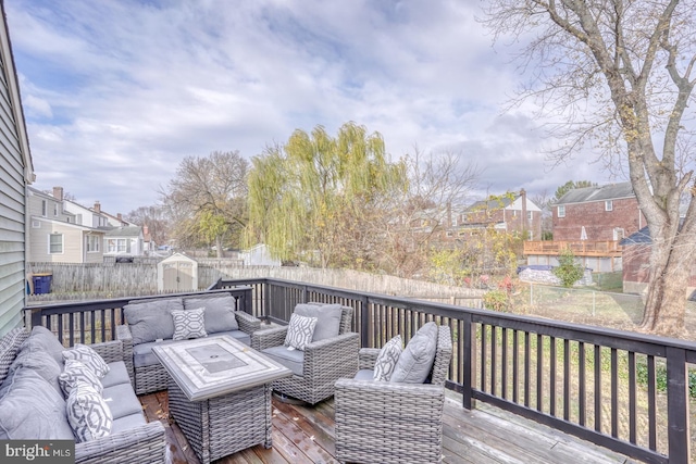 wooden deck featuring an outdoor living space and a shed