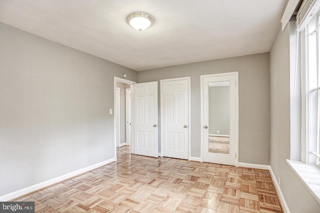 unfurnished bedroom with light parquet flooring