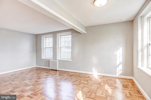 empty room with radiator and light parquet flooring