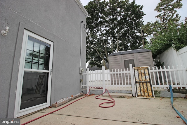 view of patio featuring a storage unit