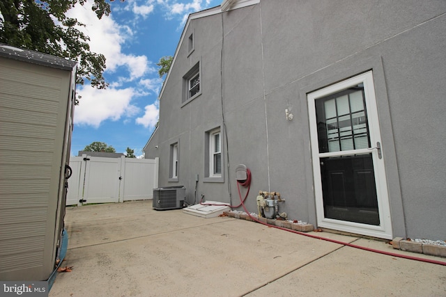 view of property exterior featuring central AC and a patio area