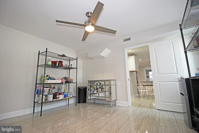 interior space with ceiling fan