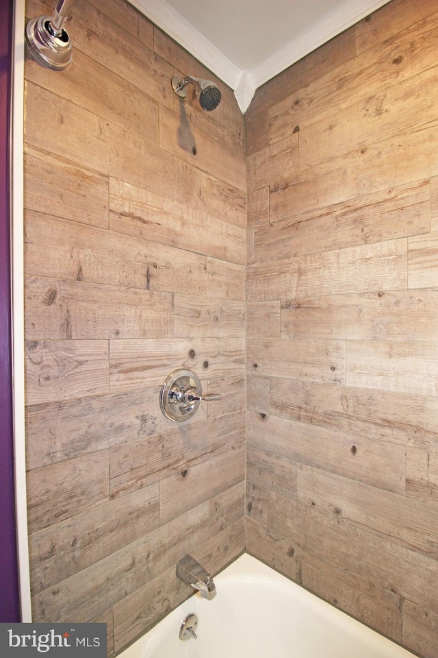 bathroom featuring shower / tub combination and wooden walls