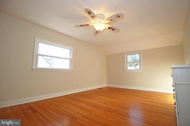 empty room with vaulted ceiling, light hardwood / wood-style flooring, and ceiling fan