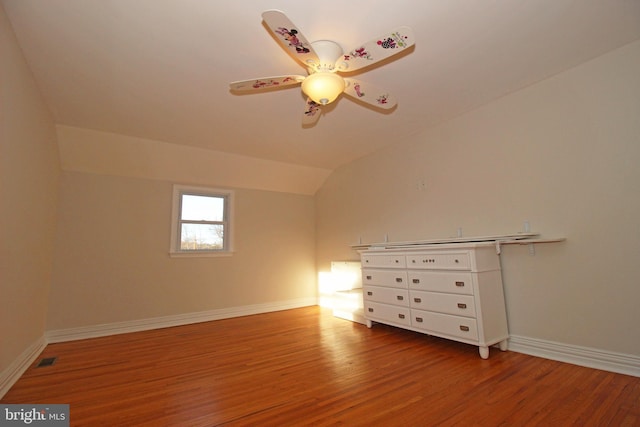 additional living space with ceiling fan, hardwood / wood-style floors, and lofted ceiling