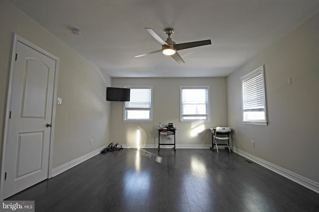 unfurnished room with dark hardwood / wood-style floors and ceiling fan