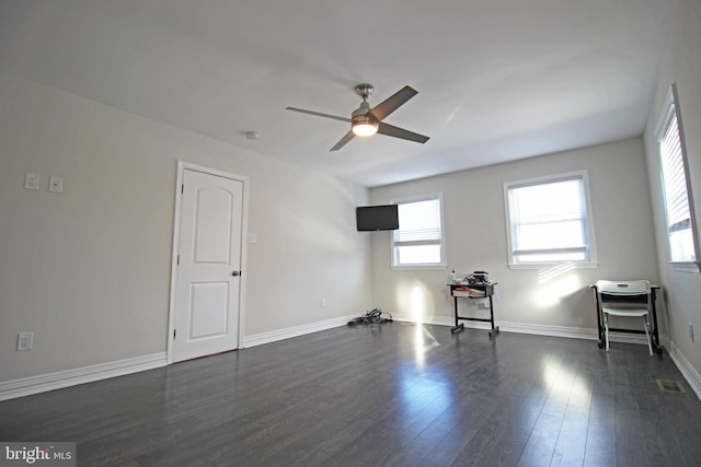 spare room with ceiling fan and dark hardwood / wood-style floors