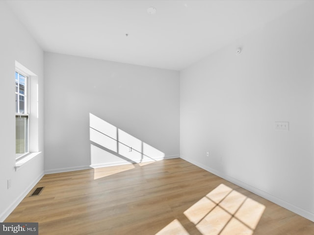 spare room featuring light wood-type flooring