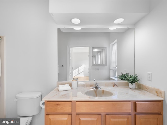 bathroom featuring vanity and toilet