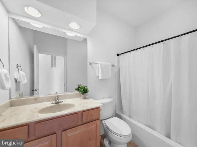 full bathroom featuring vanity, toilet, and shower / tub combo with curtain