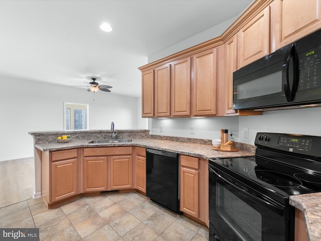 kitchen featuring light stone countertops, ceiling fan, sink, and black appliances