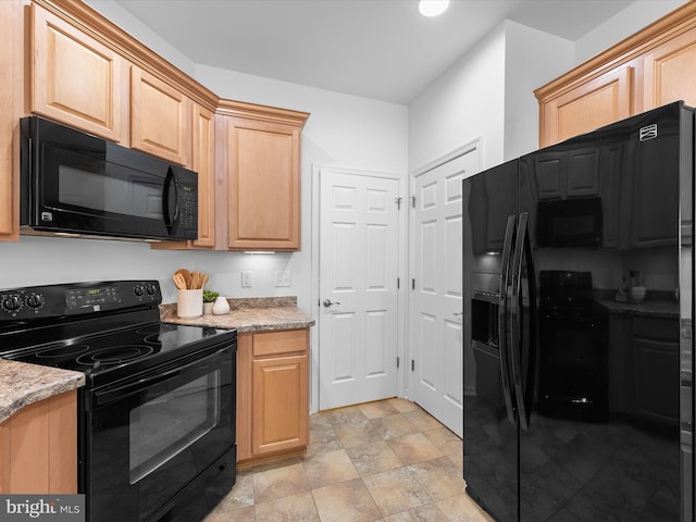 kitchen with black appliances, light brown cabinets, and light stone countertops