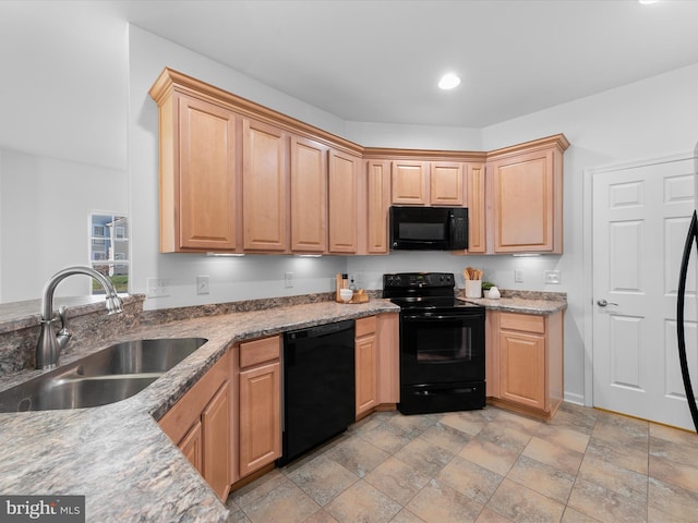 kitchen with light stone counters, sink, black appliances, and light brown cabinets