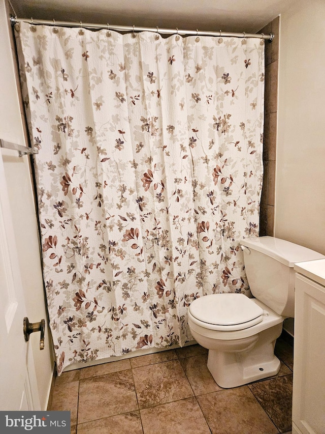 bathroom featuring tile patterned flooring, vanity, and toilet