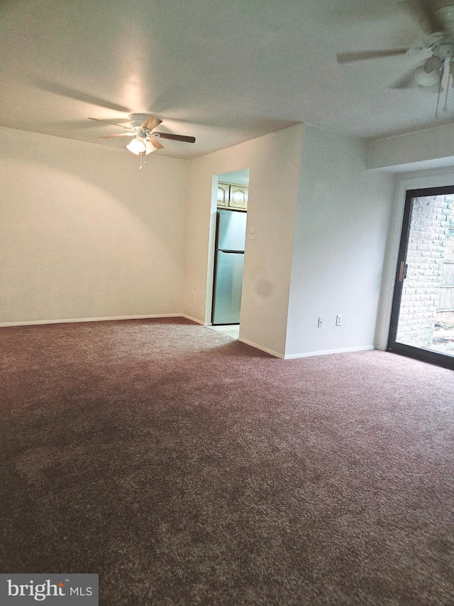 spare room with ceiling fan and carpet floors