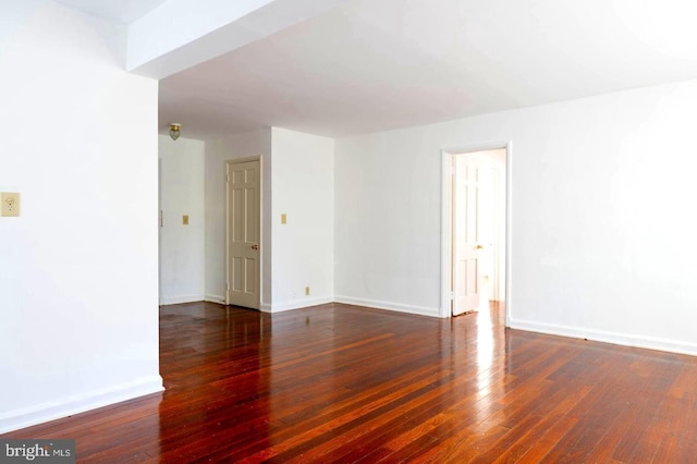 spare room with dark hardwood / wood-style floors