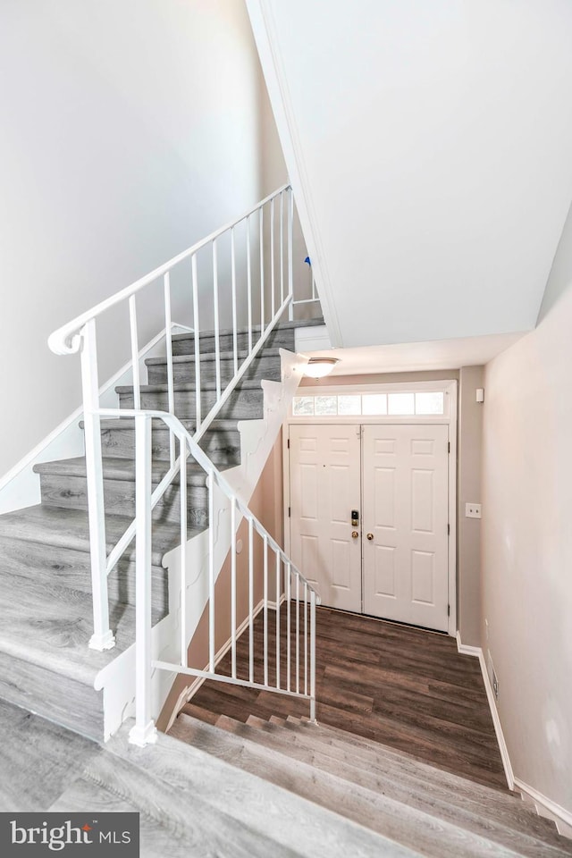 stairway featuring wood-type flooring