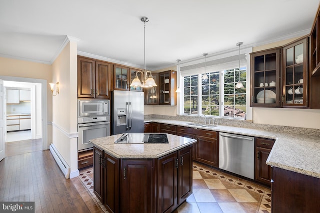 kitchen with a center island, hanging light fixtures, a baseboard radiator, dark hardwood / wood-style flooring, and appliances with stainless steel finishes