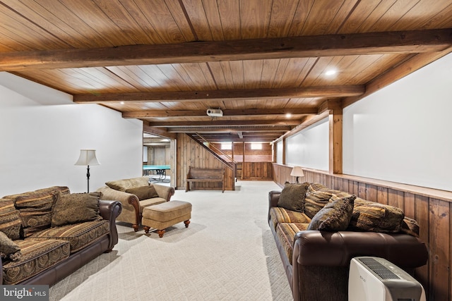 living room featuring wood ceiling, wooden walls, beamed ceiling, and light colored carpet