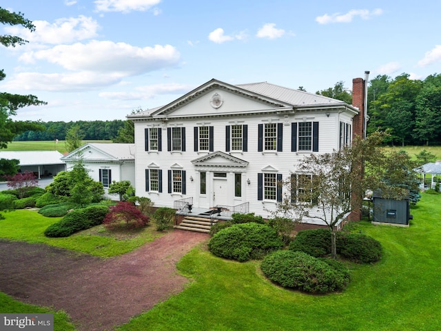 greek revival inspired property with a front lawn