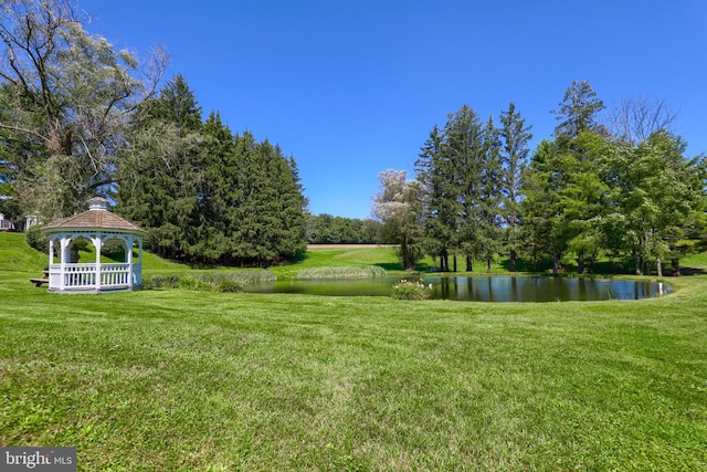 view of yard with a gazebo and a water view