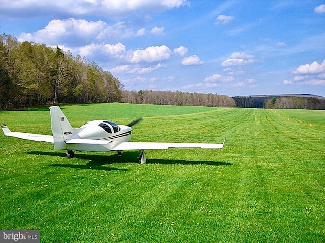 surrounding community with a rural view and a lawn