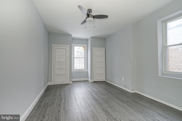 spare room with ceiling fan and dark hardwood / wood-style floors