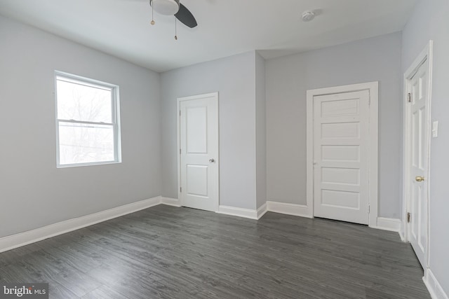 unfurnished bedroom featuring ceiling fan and dark wood-type flooring