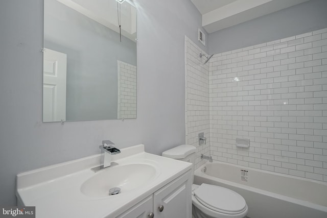 full bathroom featuring vanity, tiled shower / bath combo, and toilet