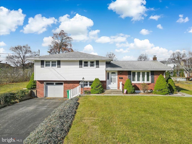 split level home with a garage and a front yard