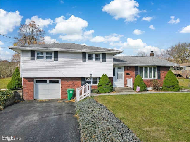 split level home featuring a front lawn and a garage