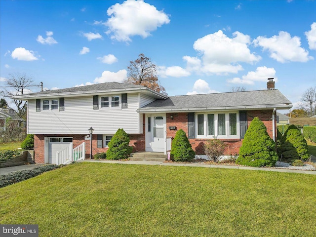 tri-level home with a garage and a front lawn